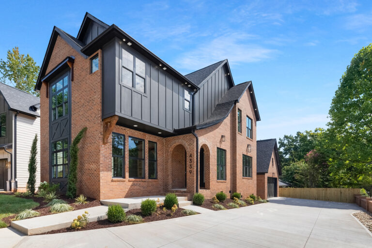 Brick and black board-and-batten two-story exterior
